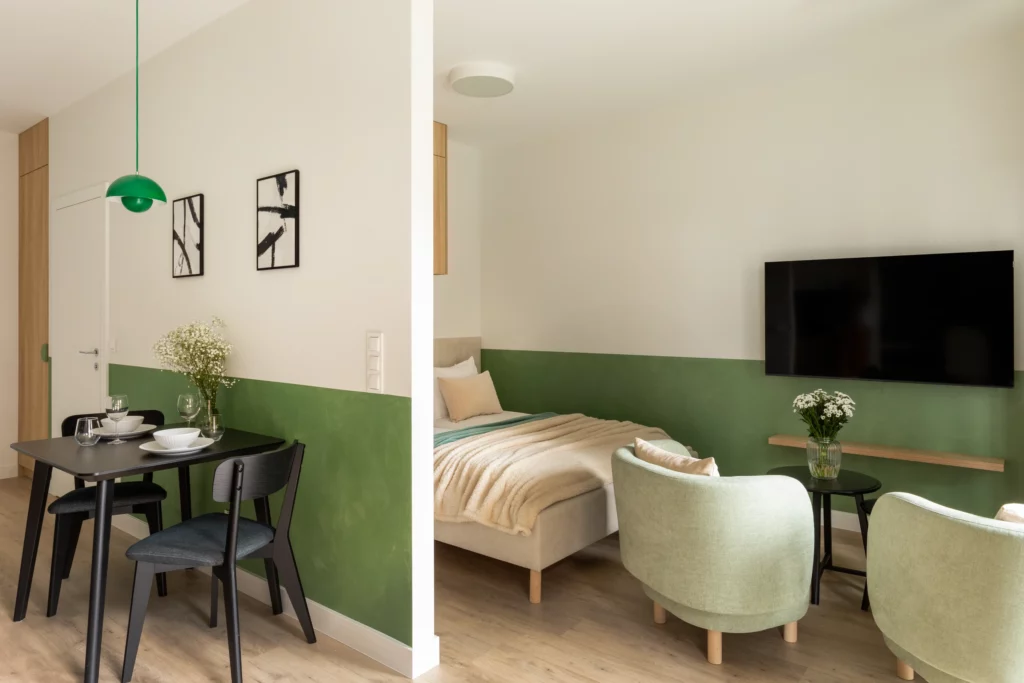 Jadalnia przy zielonej zabudowie kuchennej w Trevi Studio+ Katowice Góreckiego